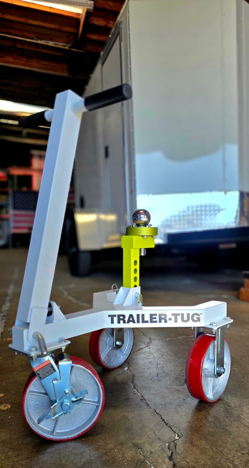 Trailer-Tug with the stabilizer installed on a concrete floor with a trailer in the background